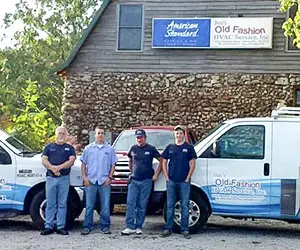 The Rock Barn with AC repair technicians standing in front of HVAC service trucks in Bentonville AR